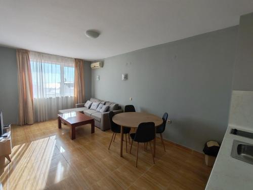 a living room with a table and a couch at Magic Dreams Apartments in Sveti Vlas