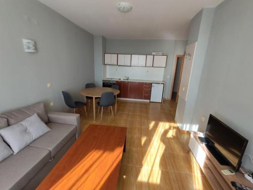 a living room with a couch and a table at Magic Dreams Apartments in Sveti Vlas