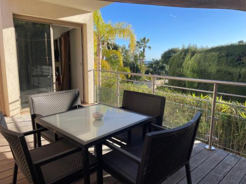 a table and chairs on a deck with a view at Cannes Villa St Barth in Cannes