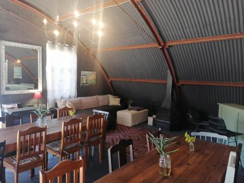 a room with a table and chairs and a couch at Hawklee Country House in Nottingham Road