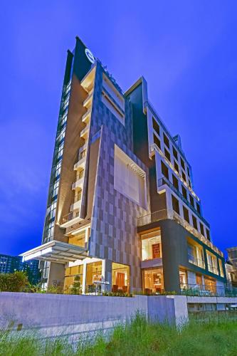 a tall building with a lot of windows at Clarion Hotel Khayal Kochi, Infopark in Kakkanad