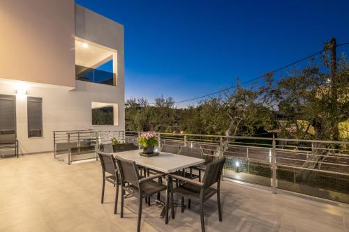 a dining room with a table and chairs on a patio at Villa Jolla-Private Pool-Ideal for big groups By Villa Mana Gers in Kalamaki