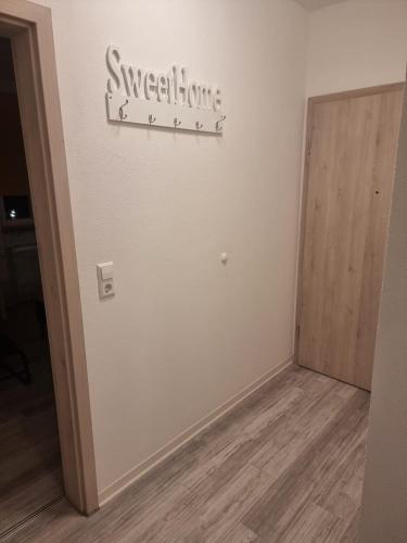 a room with a door and a sign on the wall at BK City Apartments 2 in Backnang
