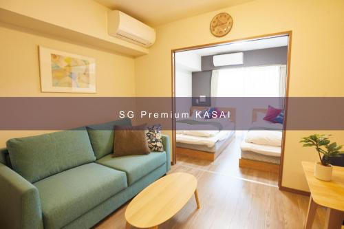 a living room with a couch and a mirror at SG Premium KASAI in Tokyo