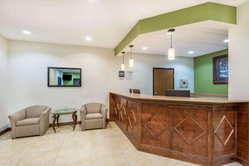 a lobby with a reception desk and chairs at Days Inn by Wyndham Topeka in Topeka