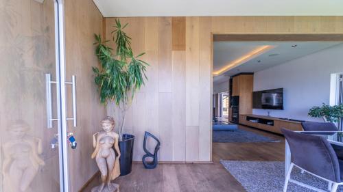 a living room with a statue of a boy on the wall at Exclusive 3-Bedroom Luxury Villa Cape Town CBD in Cape Town