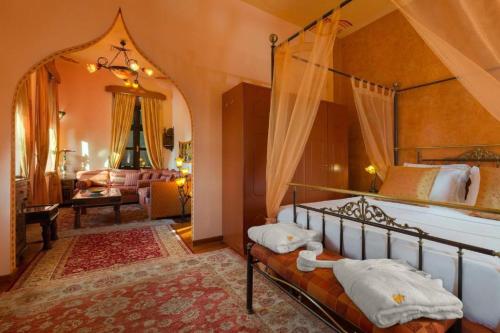 a bedroom with a canopy bed and a living room at Nikos Takis Boutique Fashion hotel in Rhodes Town
