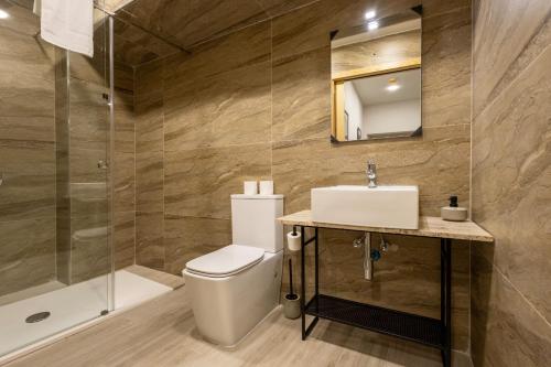 a bathroom with a toilet and a sink and a shower at Piccolin Studios by GB Apts in Valletta