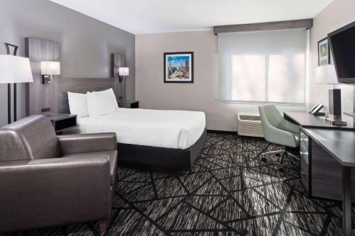 a hotel room with a bed and a desk at La Quinta Inn by Wyndham Cleveland Independence in Independence