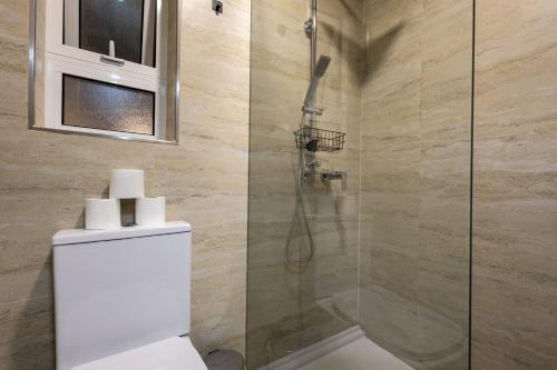 a bathroom with a shower and a toilet in it at Piccolin Studios by GB Apts in Valletta