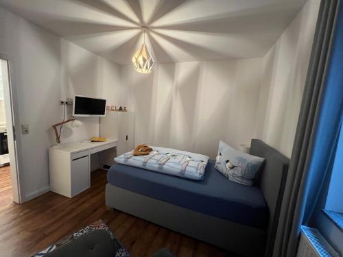 a small bedroom with a bed and a desk at Mara in Lübeck