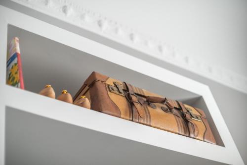 a shelf with five shoes sitting on top of it at Family Affair Luxury Rooms&Suites in Palermo