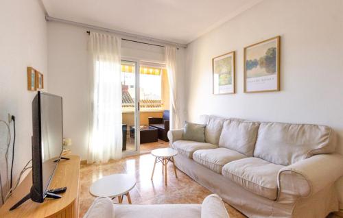 a living room with a couch and a tv at 3 Bedroom Cozy Apartment In Torrevieja in Torrevieja