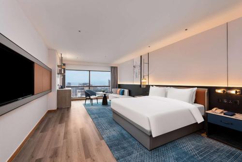 Ένα ή περισσότερα κρεβάτια σε δωμάτιο στο Wyndham Putian Downtown