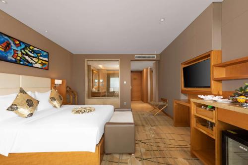 Ένα ή περισσότερα κρεβάτια σε δωμάτιο στο Wyndham Putian Downtown