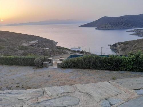 a view of a large body of water with the sunset at Andros Eco Home in Gavrion