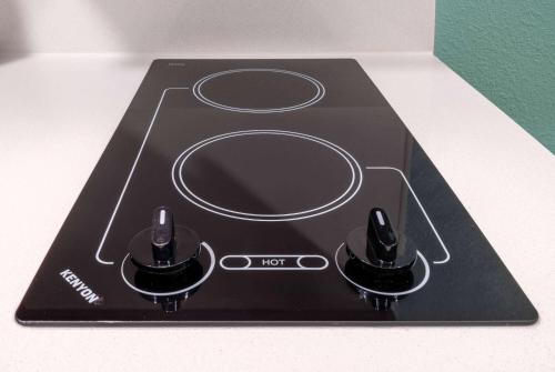 a black stove top with two knobs on it at ECHO Suites Extended Stay by Wyndham Nashville/ Gallatin in Gallatin