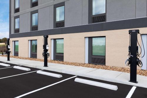 a rendering of a parking lot in front of a building at ECHO Suites Extended Stay by Wyndham Nashville/ Gallatin in Gallatin