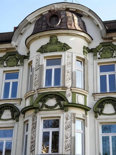 a tall building with windows and a dome at Apartament na Granicy 5 in Cieszyn