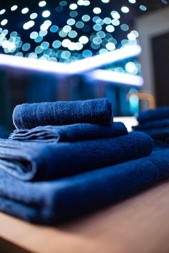 a pile of blue towels sitting on top of a table at Noctis Amoris Suite Atypique Maizeret in Samson