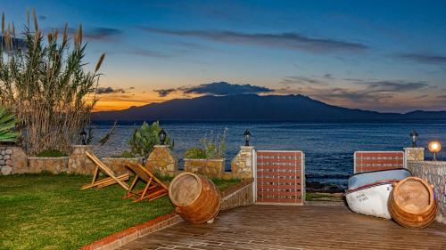 a patio with a view of the ocean and mountains at Julia's Cosy Apt in Ravdhoúkha