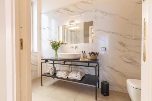 a bathroom with a sink and a mirror at Family Affair Luxury Rooms&Suites in Palermo