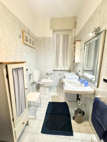 a bathroom with a sink and a toilet at Casa Dante in Finale Ligure
