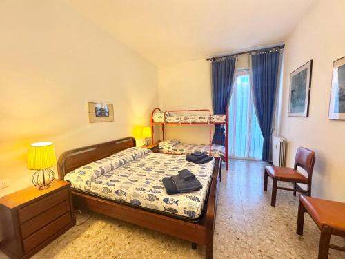 a bedroom with a bed and a table and chairs at Casa Dante in Finale Ligure