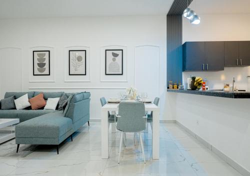 a living room with a blue couch and a table at Bright & Chic Apartment in Libreville
