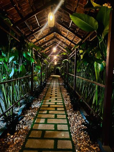 a greenhouse with plants and a light in the middle at KOTTACKAL NATURE INN in Nedumbassery