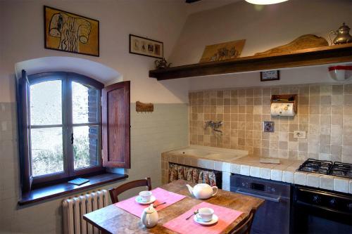a kitchen with a table and a window at Nittardi in Castellina in Chianti