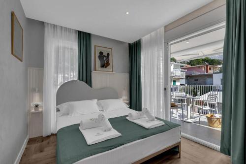 a bedroom with a bed with two towels on it at Villa Anchor in Baška Voda