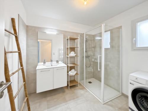 une salle de bain blanche avec une douche et un lavabo dans l'établissement Duplex T4 proche de la plage à Calvi, à Calvi