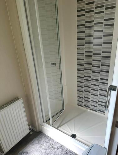 a shower with a glass door in a bathroom at The Meadows in Tattershall