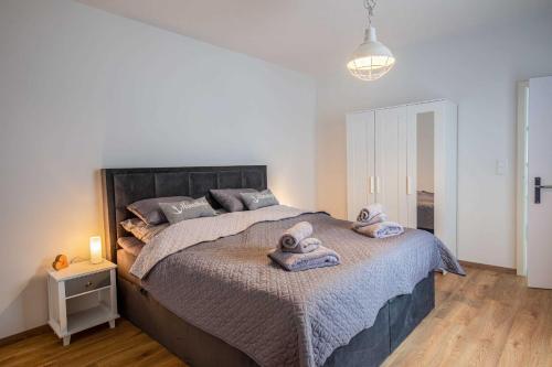 a bedroom with a large bed with towels on it at Ferienwohnung Alte Meierei in Gelting