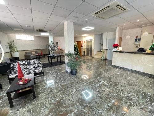 an office lobby with a marble floor and a waiting room at Hotel Avenida El Morell in El Morell