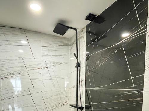 a shower with a glass door in a bathroom at КЪЩА ЗА ГОСТИ ГРОШЪ in Dobrinishte