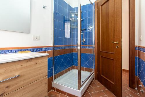 a bathroom with a shower with blue tiles at 15 miles to Rome - Affitti Brevi Italia in Riano