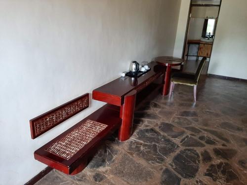 a room with a wooden table and a chair at AA Lodge Amboseli in Amboseli