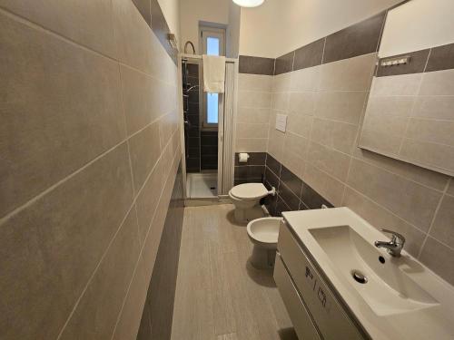 a bathroom with a toilet and a sink at B&B Via Nazionale in Milazzo