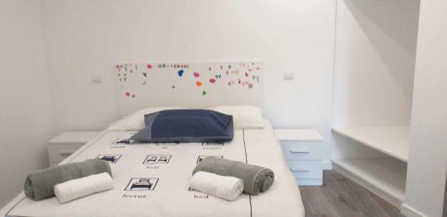 a white bedroom with a bed with two pillows at casa de campo in Virtelo