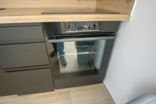 - une cuisine ouverte avec un four dans l'établissement Loft cosy au cœur du village, à Wissous