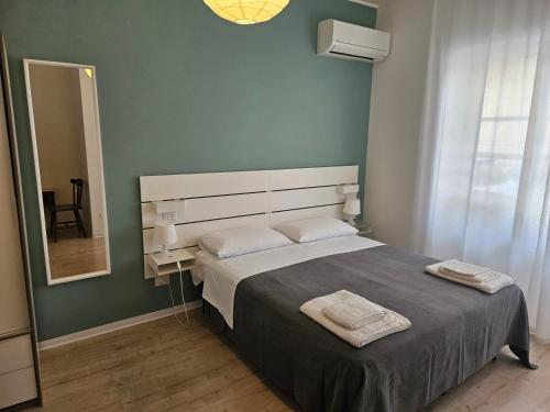 a bedroom with a large bed and a mirror at B&B Via Nazionale in Milazzo