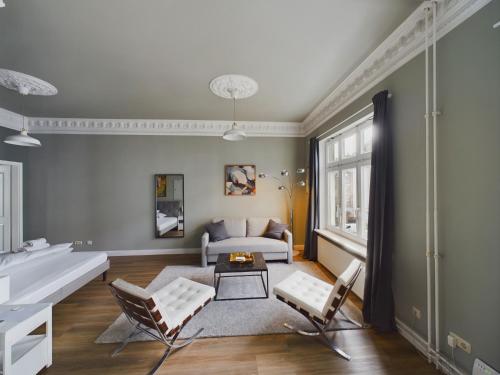 a living room with a couch and a table and chairs at Art Apartments in Hamburg