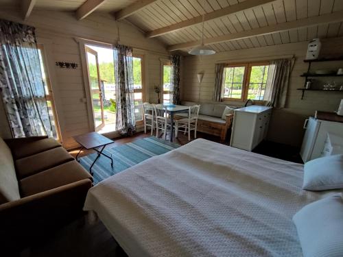 a bedroom with a bed and a table and chairs at Pyhäranta Camping & Kievari in Pyhäranta