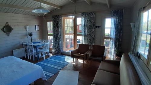 a room with a bed and a table and chairs at Pyhäranta Camping & Kievari in Pyhäranta