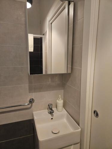 a bathroom with a sink and a mirror at B&B Via Nazionale in Milazzo