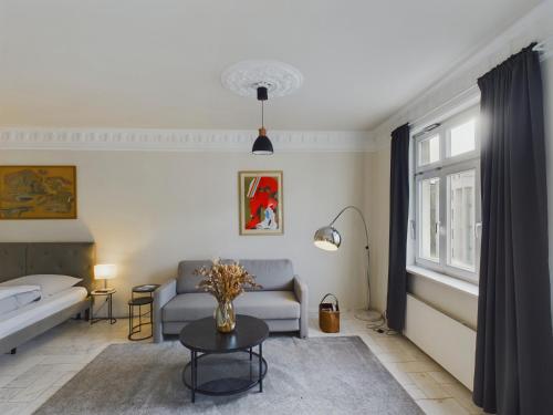 a living room with a couch and a table at Art Apartments in Hamburg