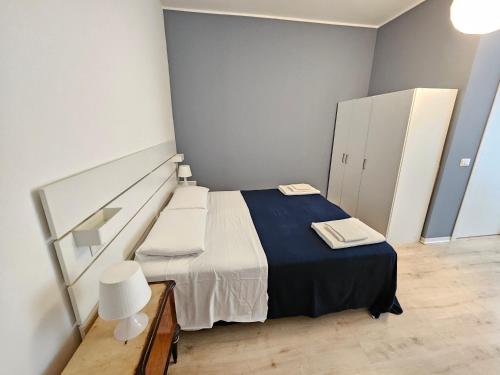 a small bedroom with a bed with a blue blanket at B&B Via Nazionale in Milazzo