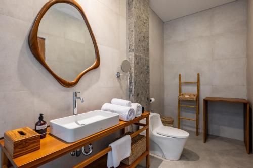 a bathroom with a sink and a mirror at Avyara Villa - Brand NEW, Luxury Tropical with Private Pool in Dalung